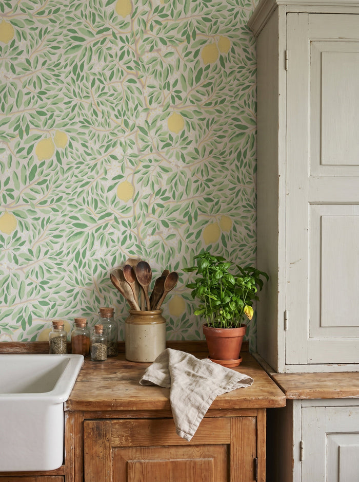 Citrus Ashy Greenery wallpaper shown on a room wall
