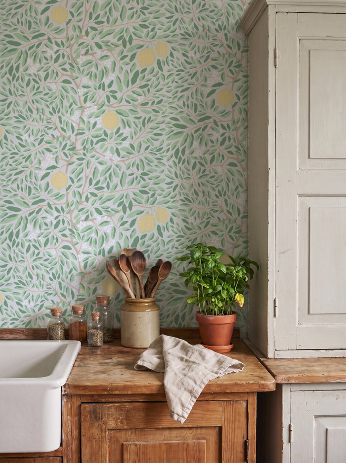 Citrus Ashy Greenery wallpaper shown on a room wall