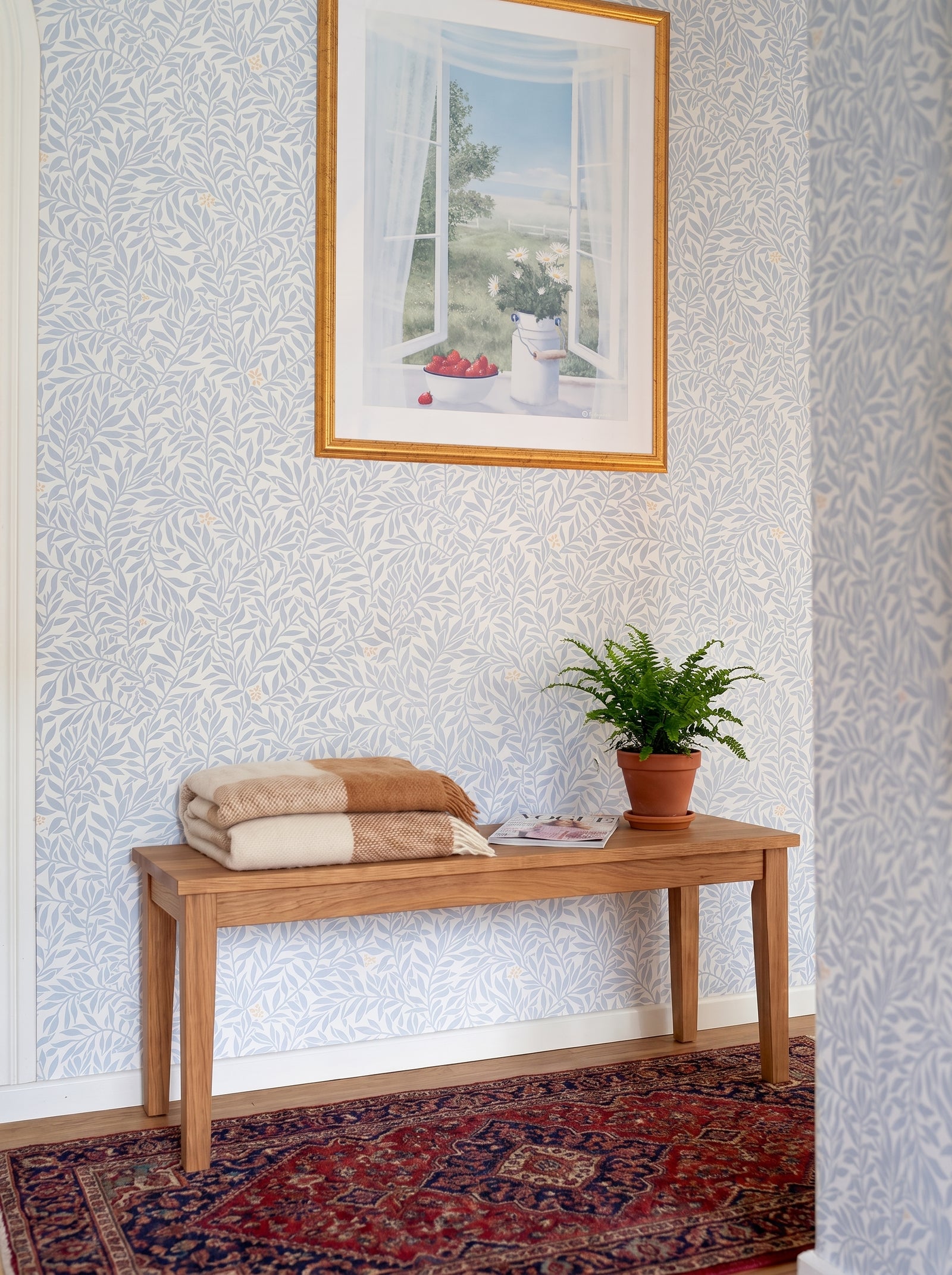 Serpentin Sunny Blue wallpaper shown on a room wall