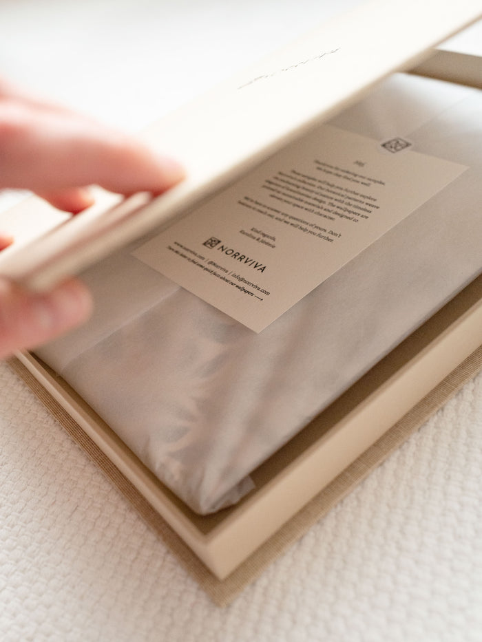 Open Norrviva sample box with wallpaper pattern swatches